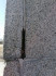Сигулда, апрель 2023, памятник Кришьянису Баронсу. Мусор и растительность в стыковочных швах облицовки постамента памятника.